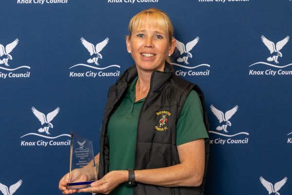 woman holding award