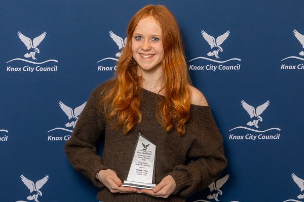 girl holding award