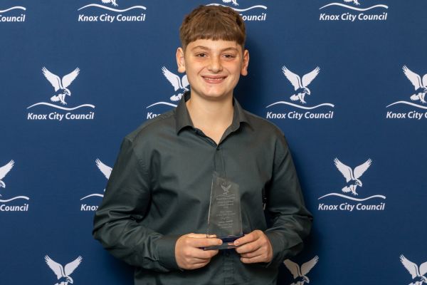 boy holding award