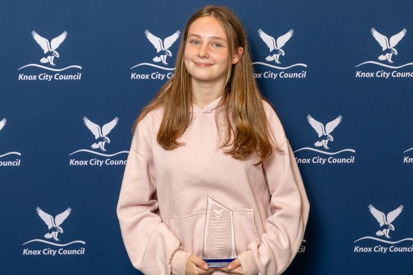 girl holding award