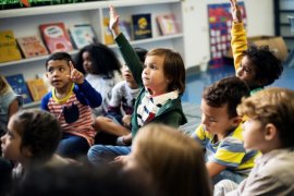 Kindergarten students sitting on the floor.