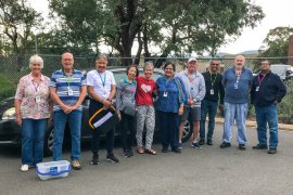 A group of meals on wheels volunteers standing together