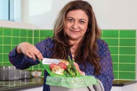 woman with food scraps and kitchen caddy