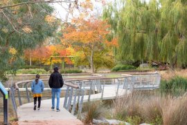 Two people walking in parkland in Knox.