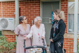 Volunteer helping a senior residents in Knox