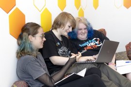 Young people looking at a laptop together