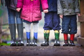 Children's feet standing in a line outside