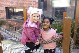 Two children playing on a bridge