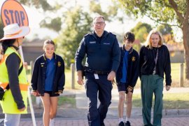 Council school crossing supervisor Lyn Chen-Sheu with Senior Sergeant Brendon de Schwartz, Assistant Principal Andrea Dowling and students Indie and Patrick at the school crossing outside Holy Trinity Primary School, Wantirna South