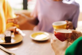 People sitting around a table having a coffee