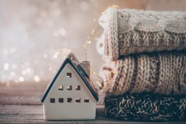 warm cozy house and sweaters on a wood table