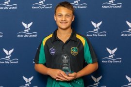 boy holding award