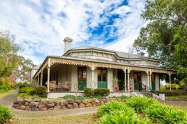 Image of Miller's Homestead front entry, veranda and garden 