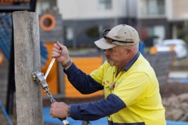 Knox City Council staff member fixing playground equipment