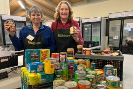 Volunteers at Outer East Foodshare collecting donations of tinned food.