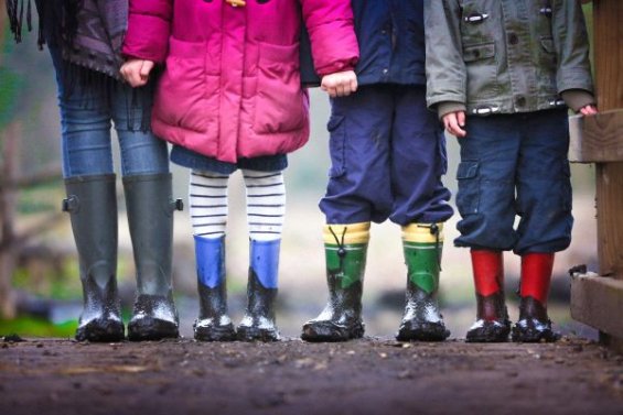 Children's feet standing in a line outside