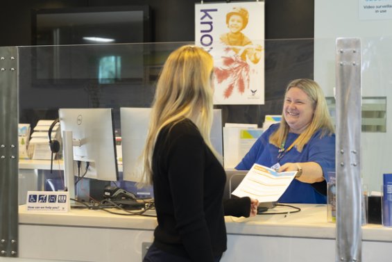 Customer being served by a staff member at Knox Council Civic Centre customer service desk 