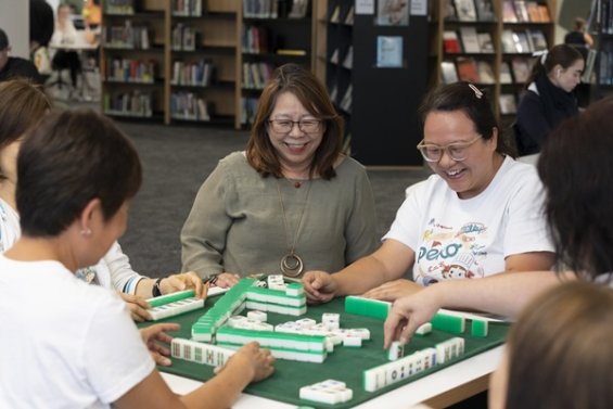 Group of people playing Mahjong