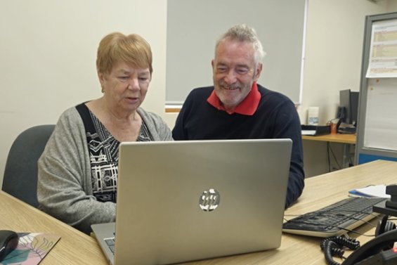 Two people looking at a laptop