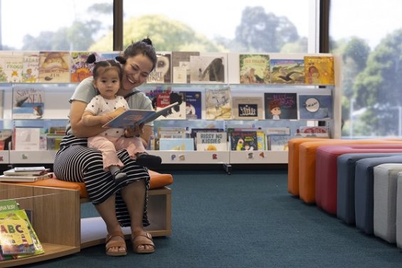 Adult and child at the Knox Library reading a book