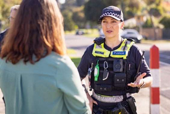 Police Officer talking with a customer member. 