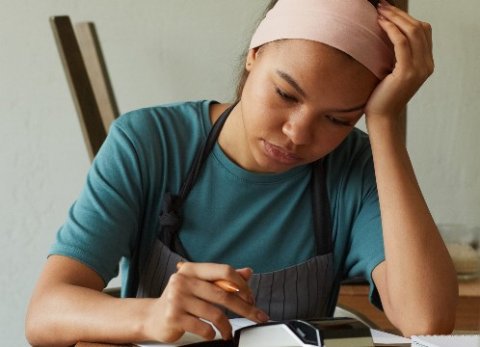 Woman using calculator to do bills