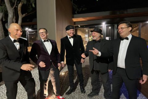 Five men in suits talking