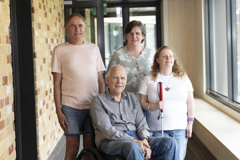 Four people smiling at the camera