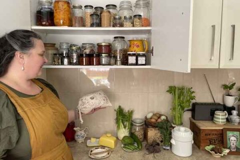 Image of person sorting and storing kitchen items
