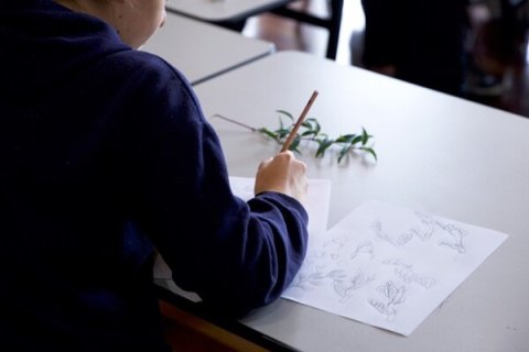 Person with a pencil and a piece of paper.