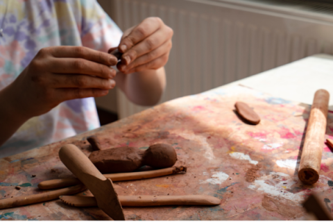 Person working with clay
