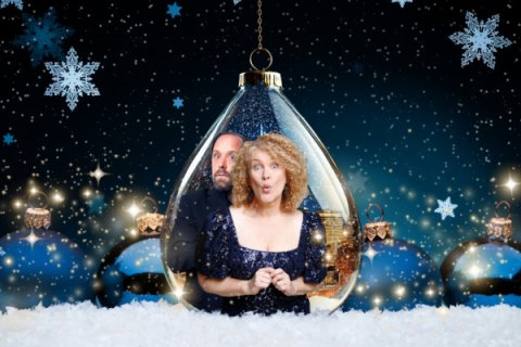 Performers Melissa Langton and Mark Jones in a Christmas bauble