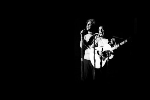 Singer and Acoustic Guitarist on stage in black and white