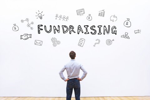 person looking up at a fundraising sign