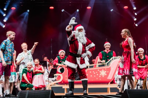 Santa waving on stage at Knox Carols
