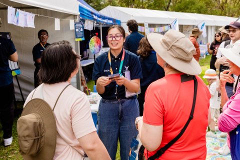 People talking at a community pop-up event 
