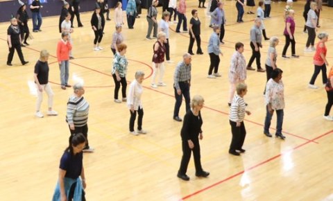A group of people line dancing