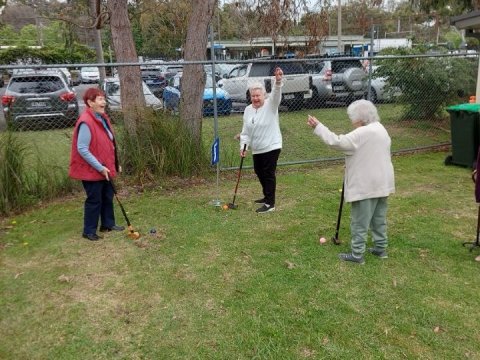 3 older people playing ground golf